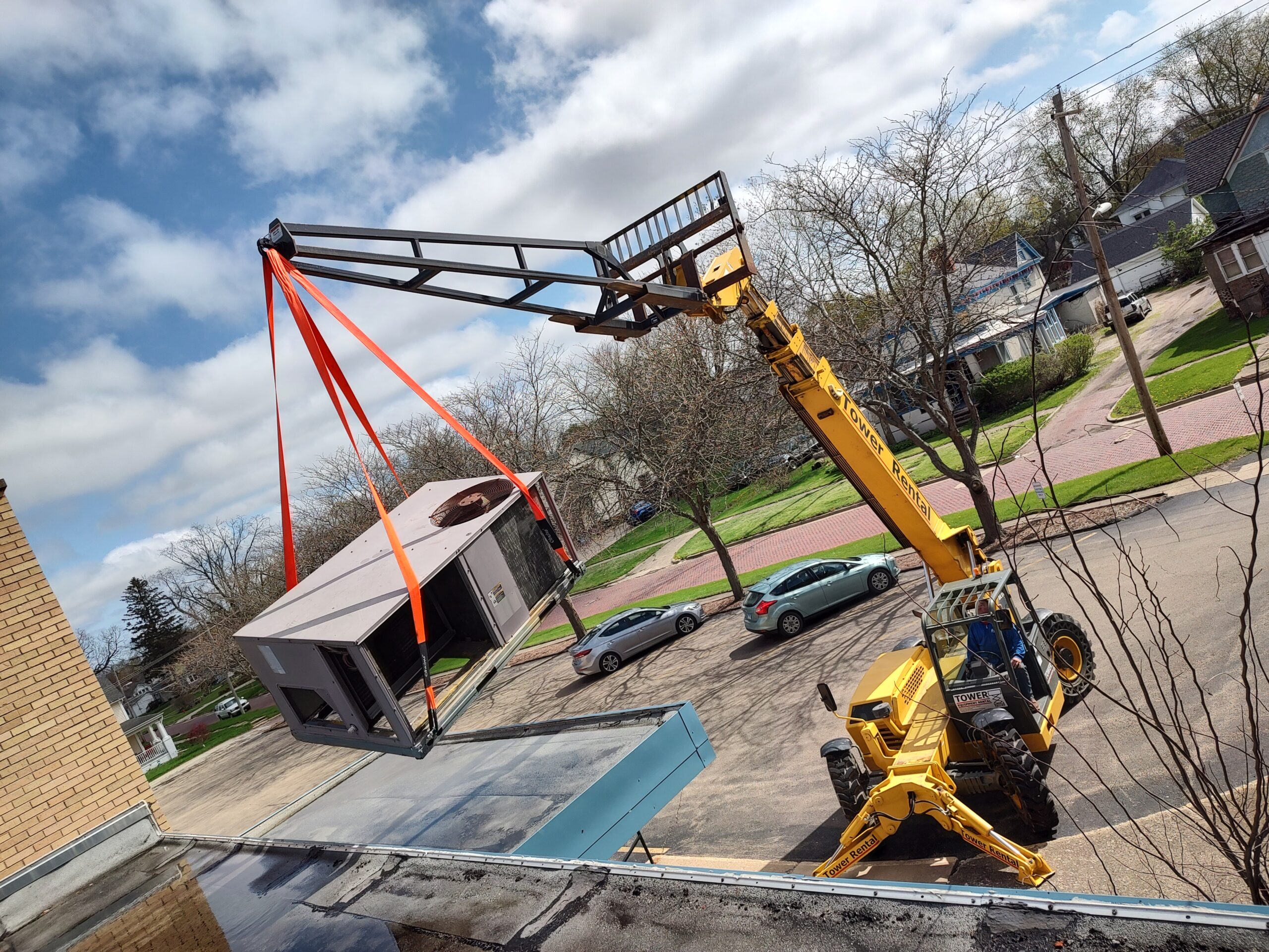 Commercial rooftop unit installation with crane